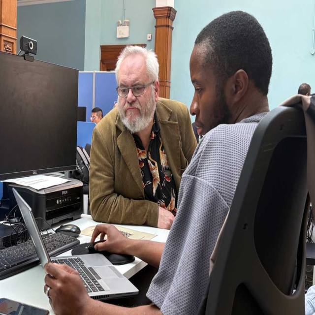 A Greenwich resident in discussion with an agent at the GLLaB office