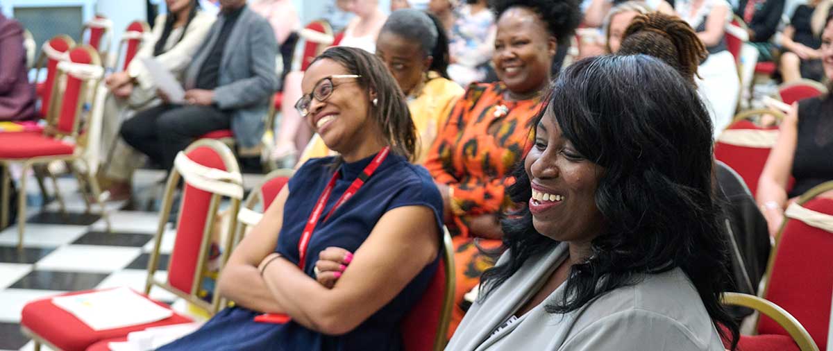 Audience members including Councillor Asli Mohammed laughing at Greenwich Learns Student and Staff 2026 Awards ceremony