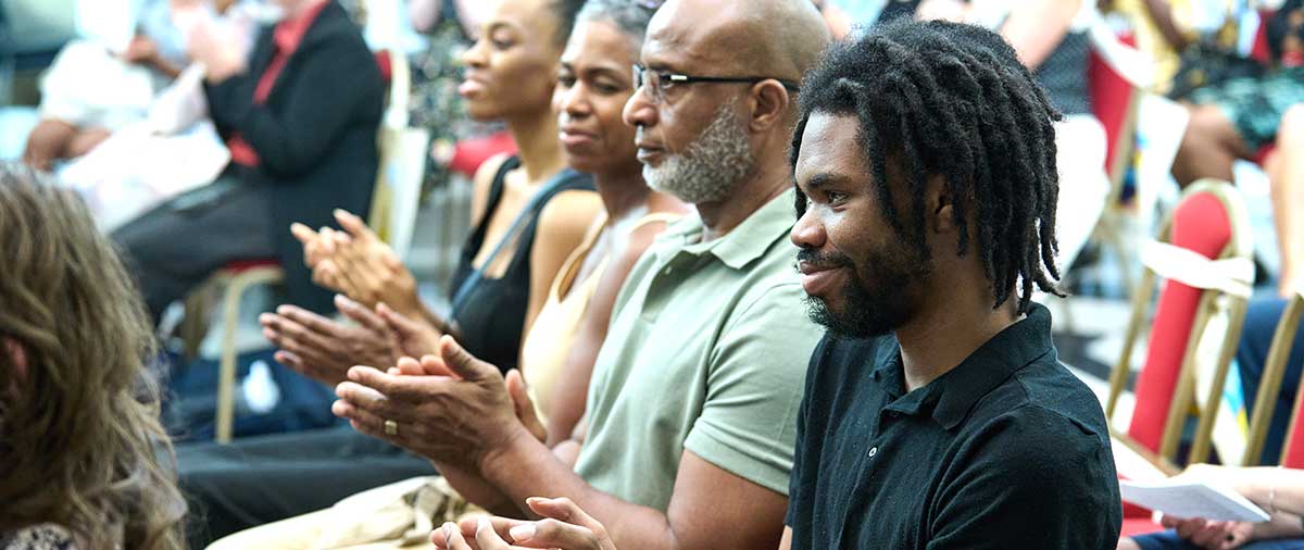 Audience members clapping during the ceremony
