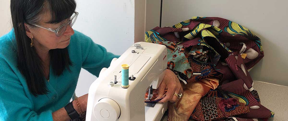 Student learning to use a sewing machine