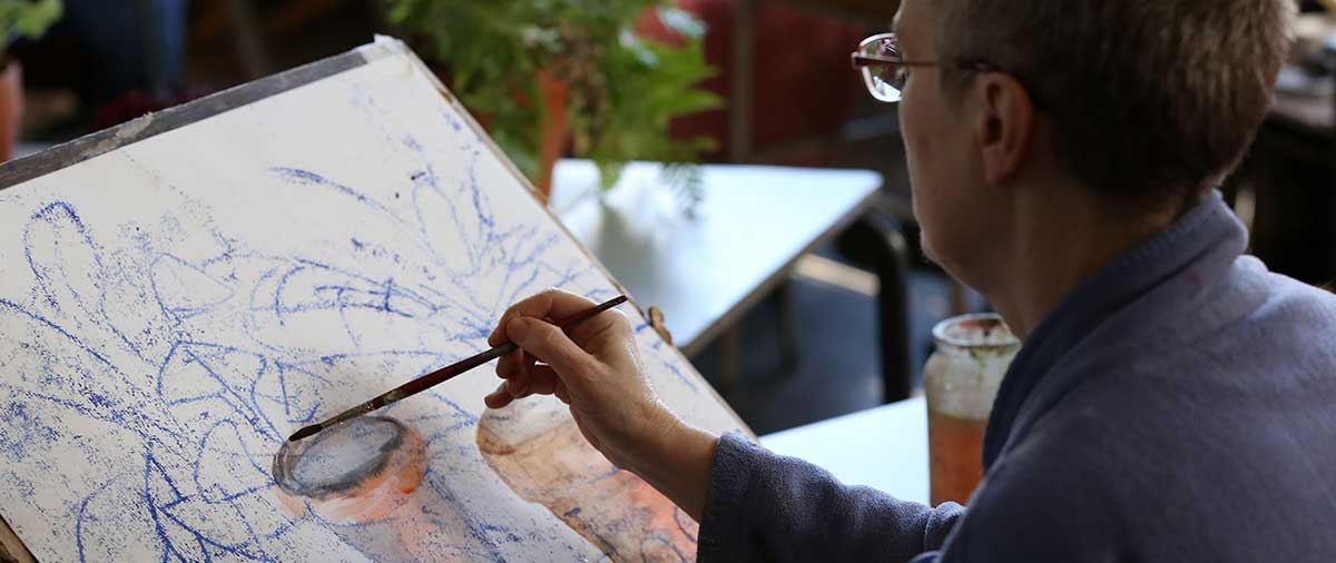 Student painting in an arts class