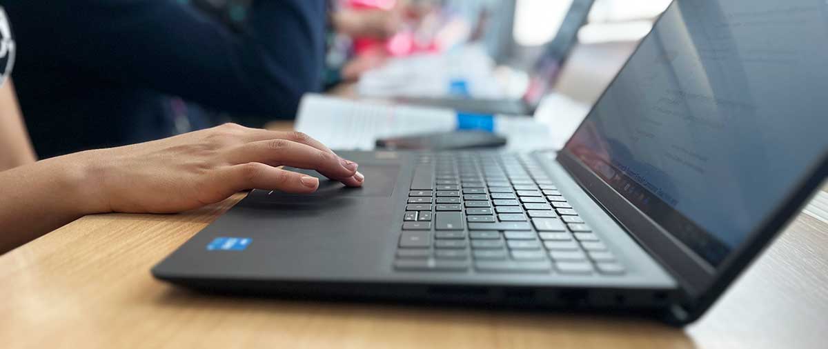 Close-up of hands typing on a computer keyboard