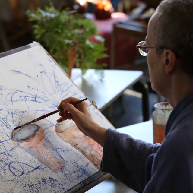 Student painting at an arts class