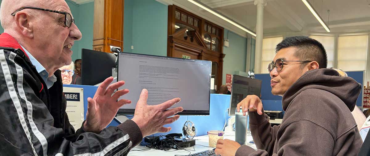 A Greenwich resident in discussion with an agent at the GLLaB office